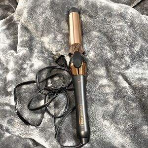 Black and rose gold curling iron.